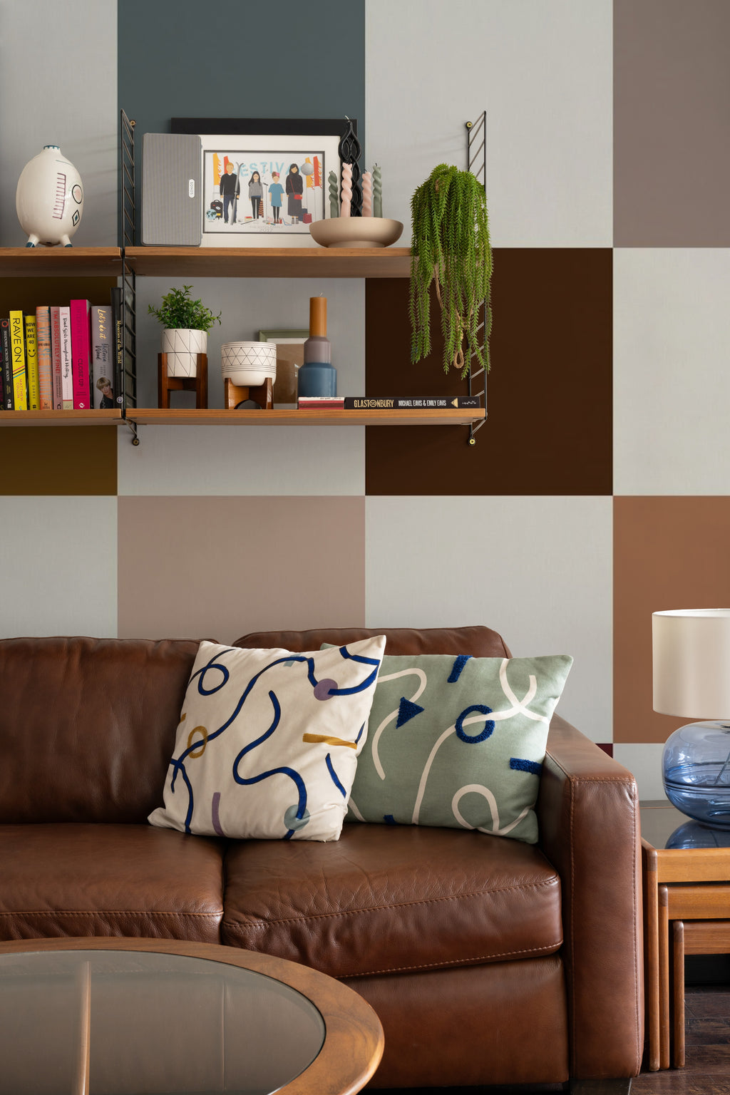 The Earthen Patchwork mural in clay and chocolate in a living room