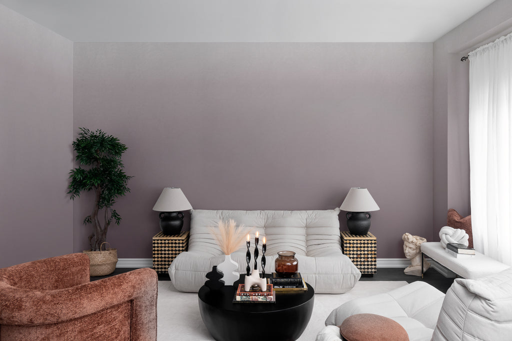 The Evening Veil mural in deep plum behind seating in a living room
