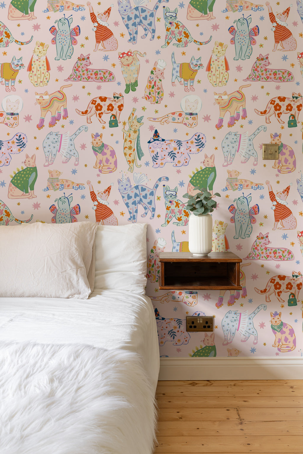 The Feline Wardrobe mural in candy pink on a nursery wall
