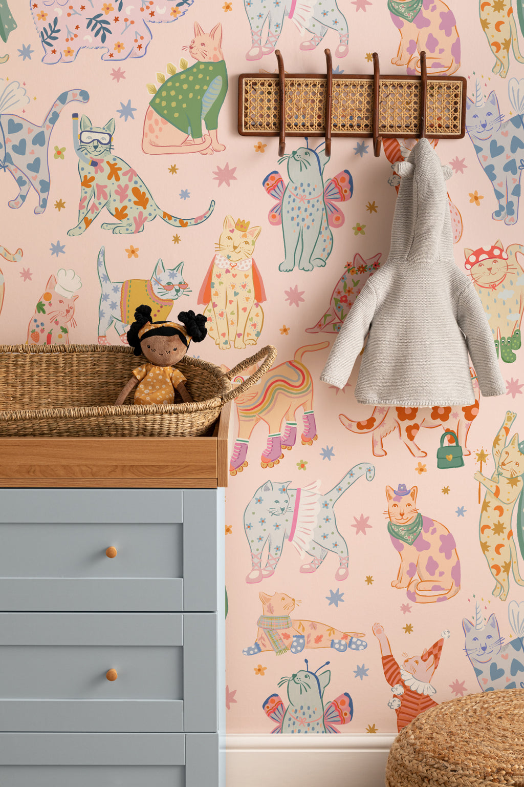 The Feline Wardrobe mural in candy pink behind a kids' play corner