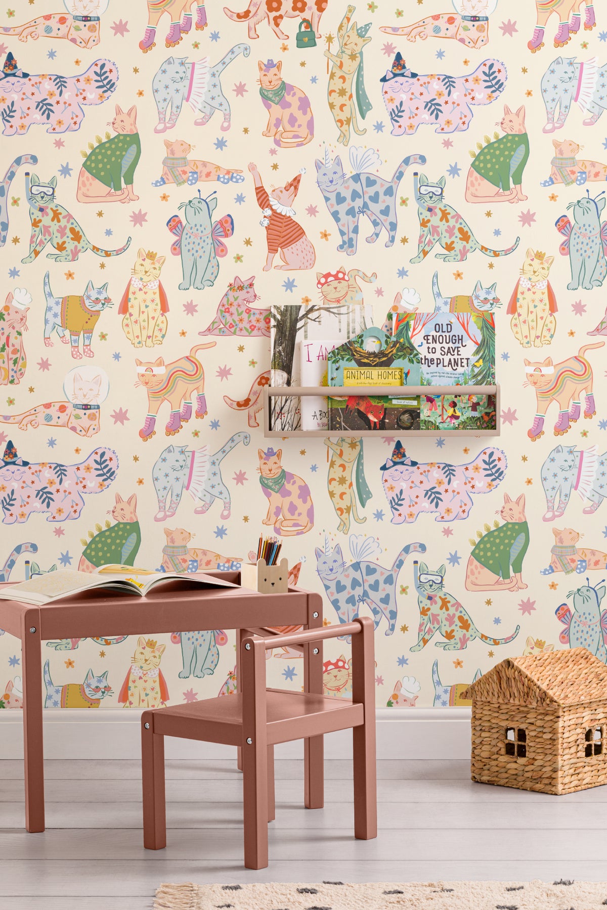 The Feline Wardrobe mural in sherbet pastel behind a kids' play corner