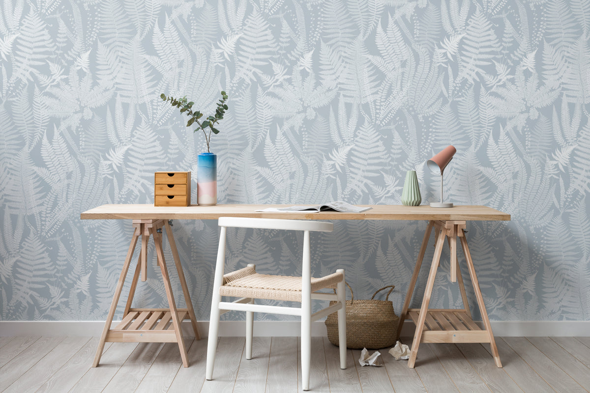 The Fernery Study wallpaper in duck egg blue behind a desk in a home office