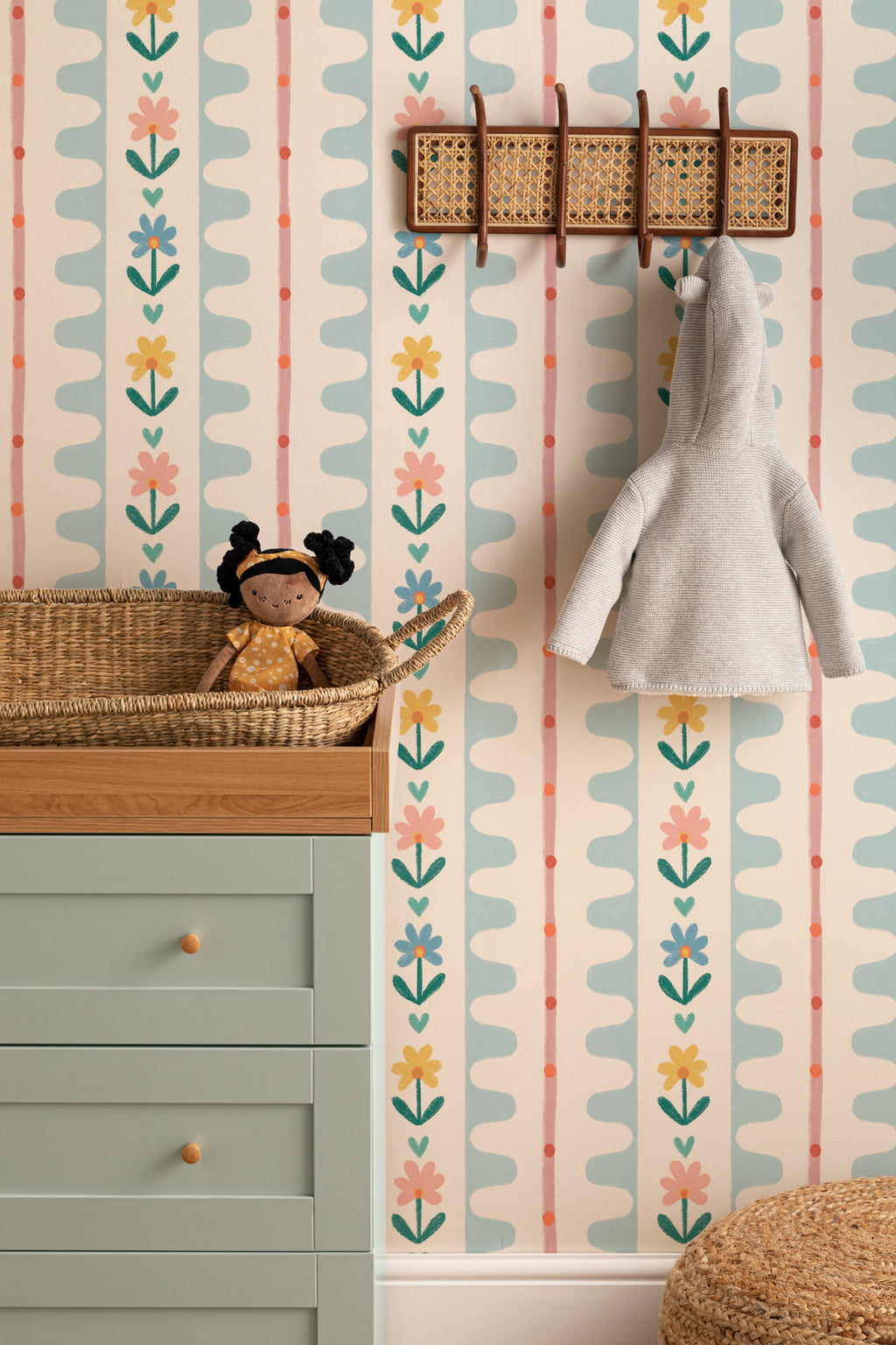 The Folk Garland mural in sky blue and buttercup on a nursery wall