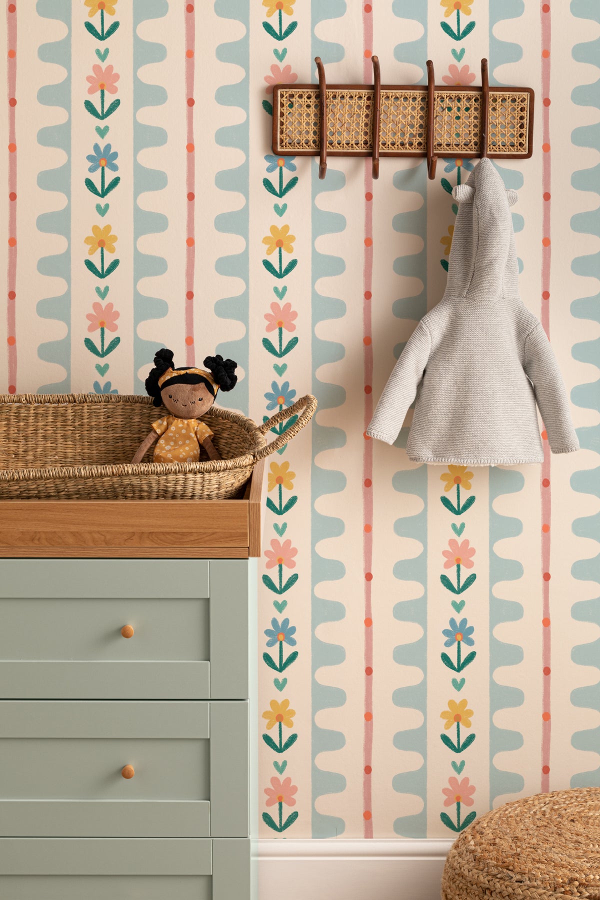 The Folk Garland mural in sky blue and buttercup on a nursery wall