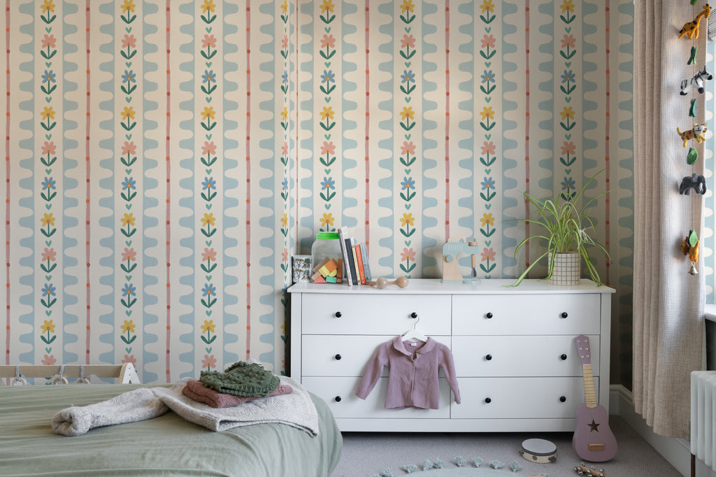 The Folk Garland mural in sky blue and buttercup in a child's bedroom