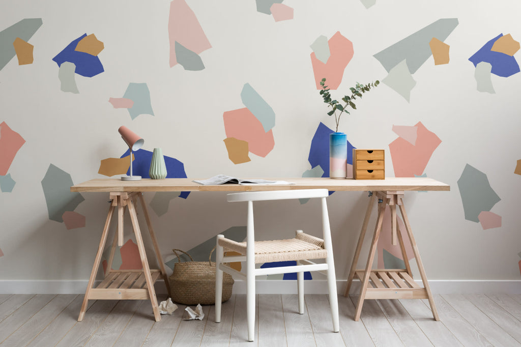 The Gallery Terrazzo mural in cobalt and coral behind a desk in a home office