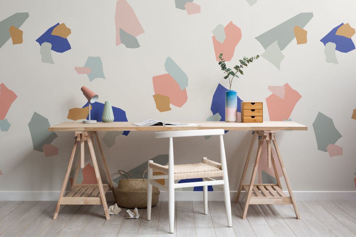 The Gallery Terrazzo mural in cobalt and coral behind a desk in a home office
