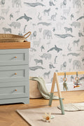 The Gentle Menagerie wallpaper in misty blue on a nursery wall