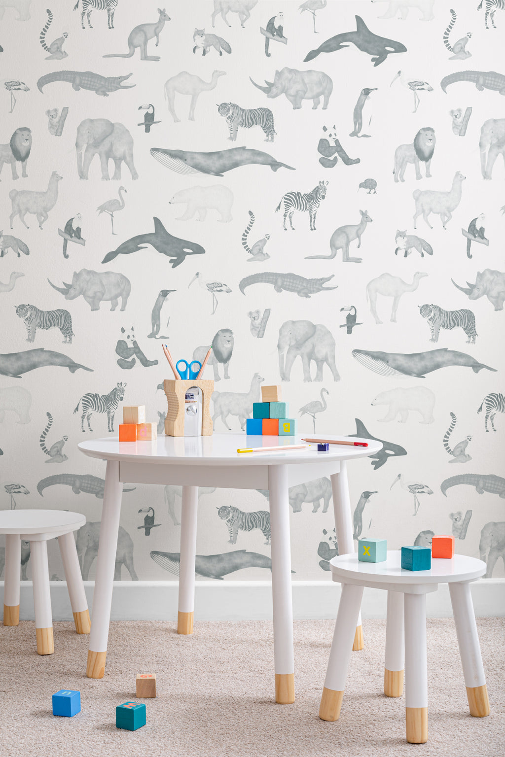 The Gentle Menagerie wallpaper in misty blue in a child's bedroom
