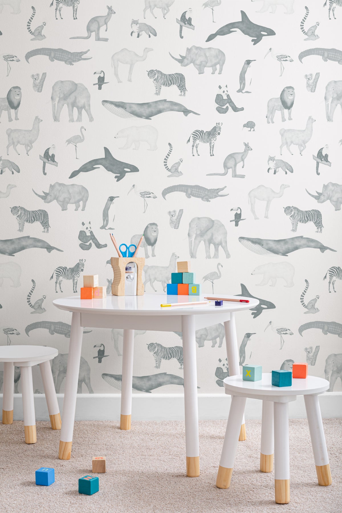 The Gentle Menagerie wallpaper in misty blue in a child's bedroom