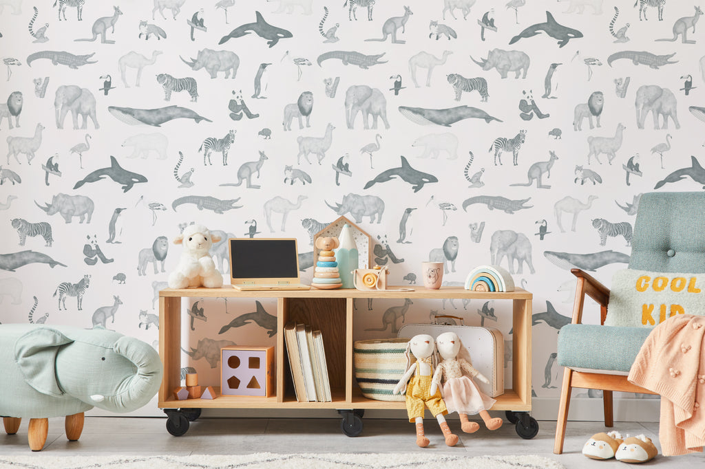 The Gentle Menagerie wallpaper in misty blue behind a kids' play corner