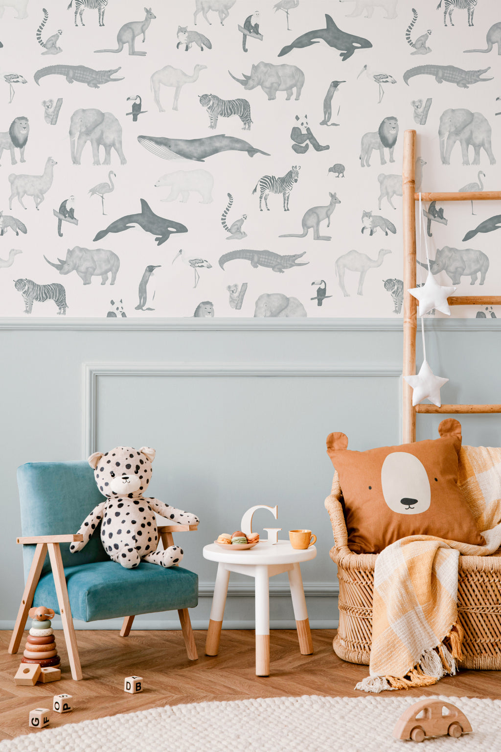 The Gentle Menagerie wallpaper in misty blue in a children's room setting