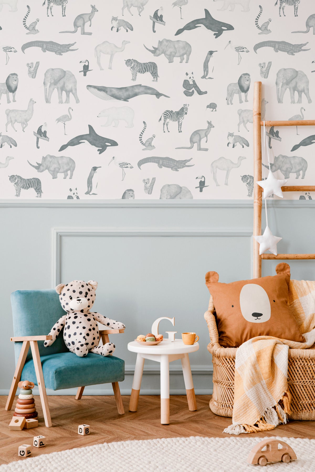 The Gentle Menagerie wallpaper in misty blue in a children's room setting
