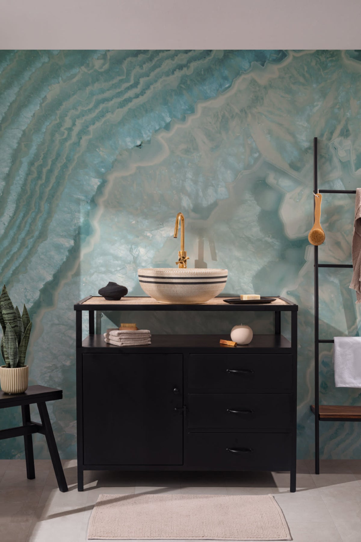 The Geode Salon mural in aquamarine behind a styled console