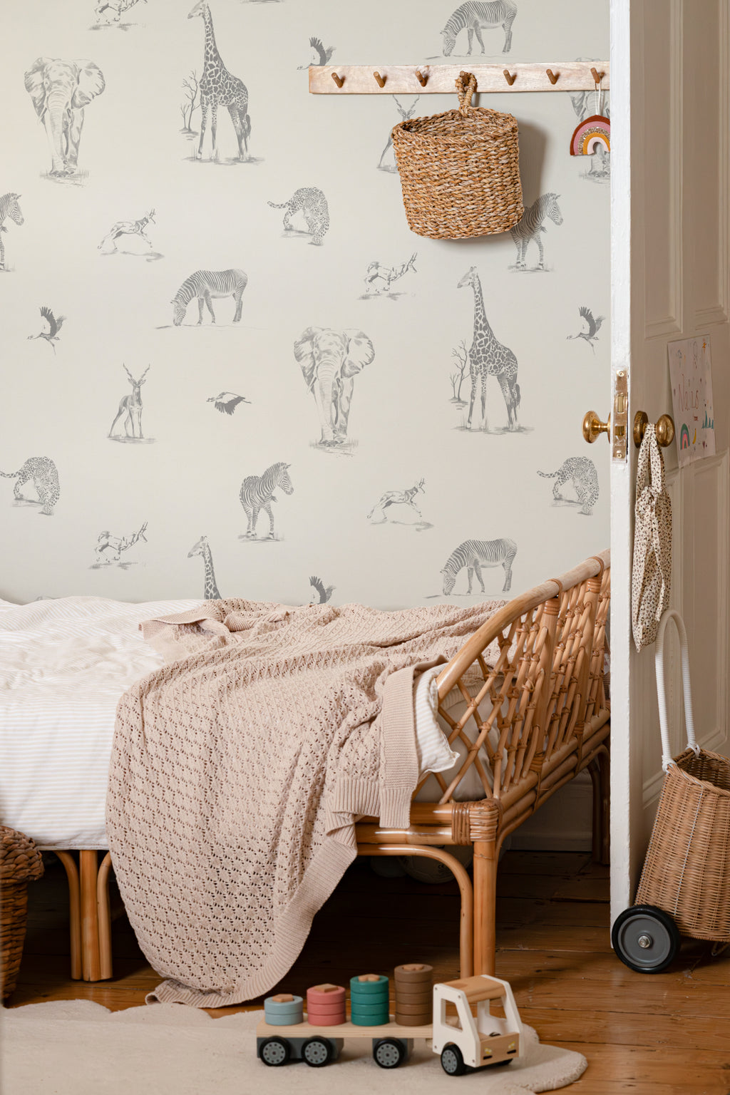 The Grassland Expedition wallpaper in dove grey and white in a child's bedroom