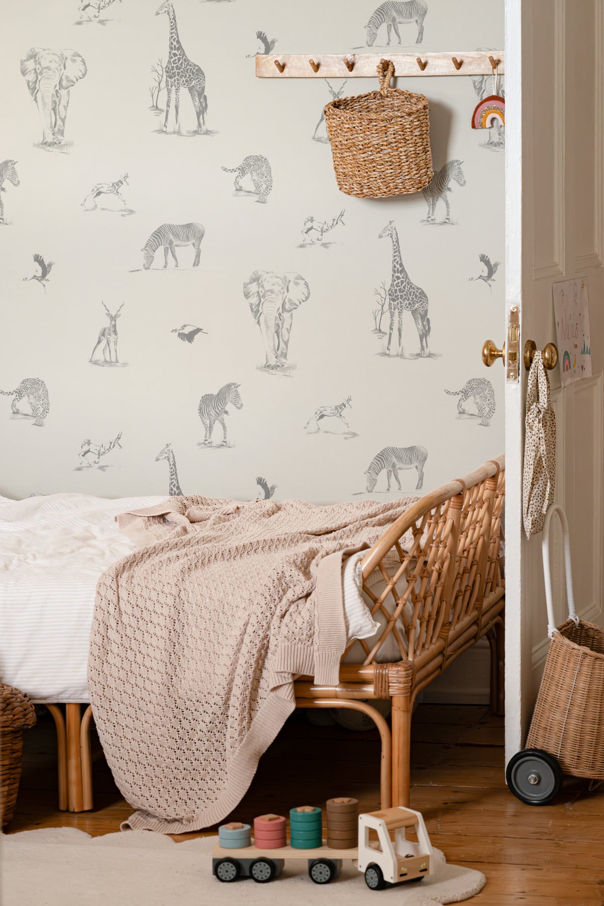 The Grassland Expedition wallpaper in dove grey and white in a child's bedroom
