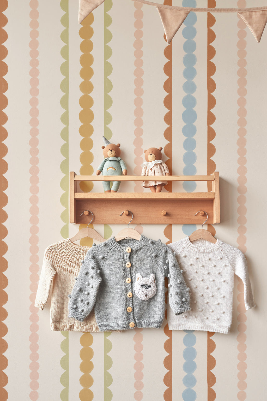 The Haberdashery Braid mural in apricot and pink on a nursery wall