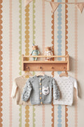 The Haberdashery Braid mural in apricot and pink on a nursery wall