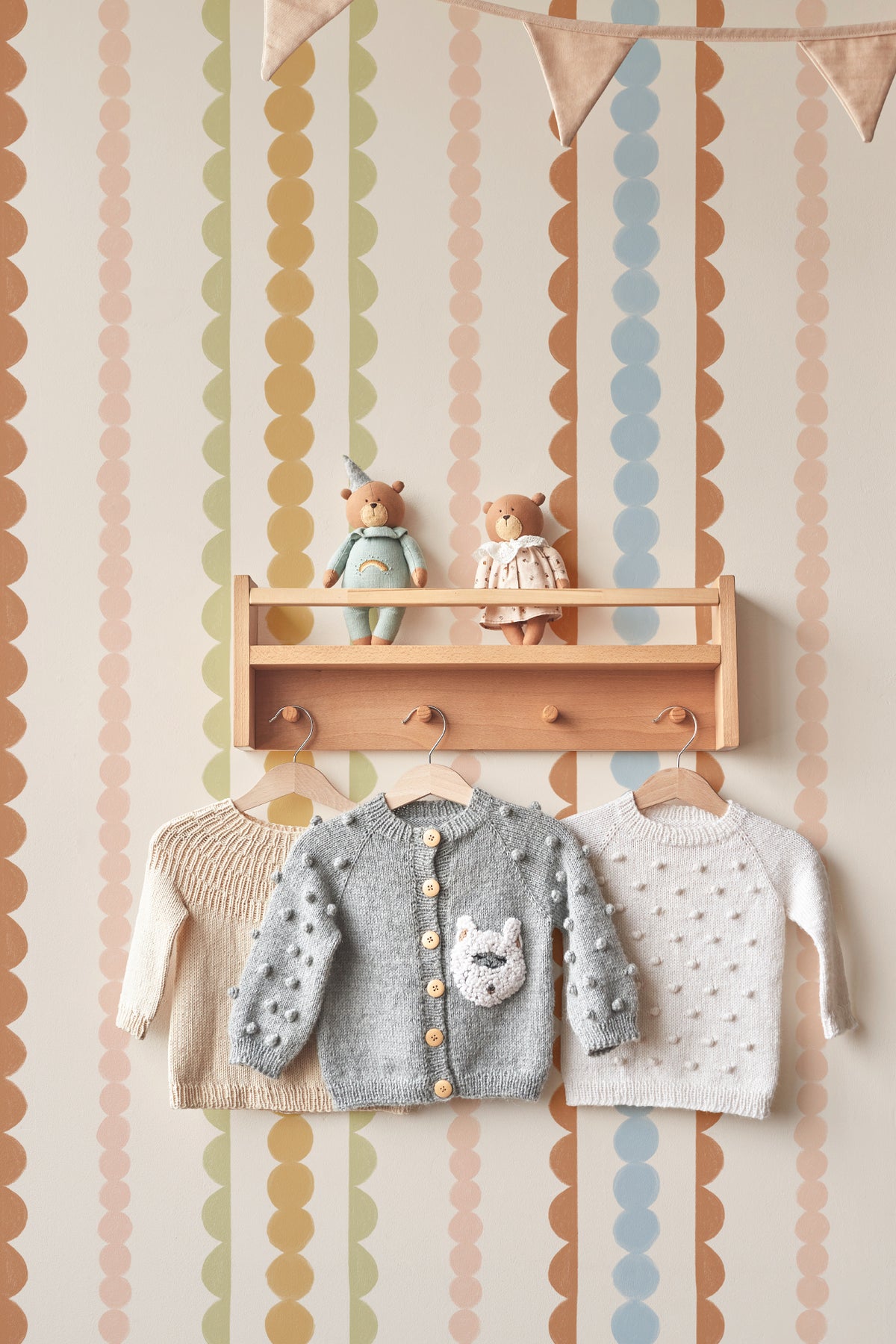 The Haberdashery Braid mural in apricot and pink on a nursery wall