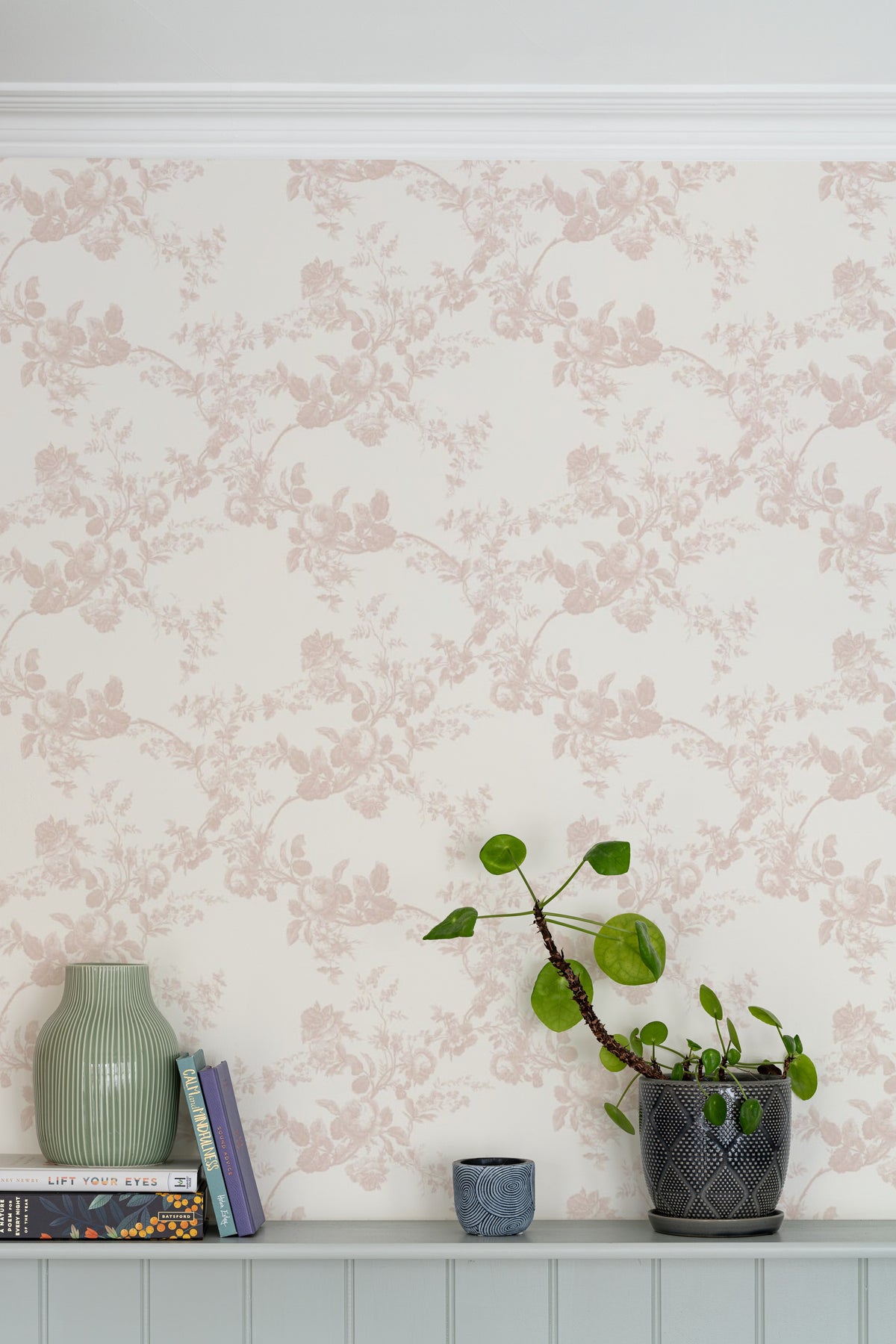 The Heirloom Rose mural in rose pink and white as a backdrop to styled furniture