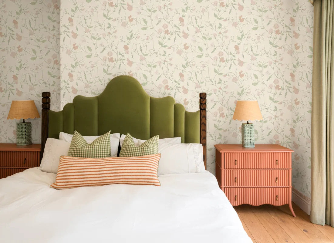 The Heirloom Sprig mural in ivory and sage behind the bed in a bedroom