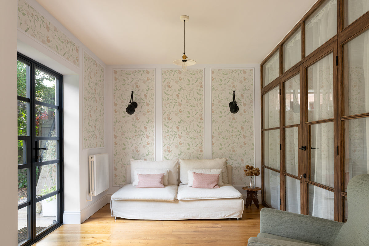 The Heirloom Sprig mural in ivory and sage in a calm bedroom setting