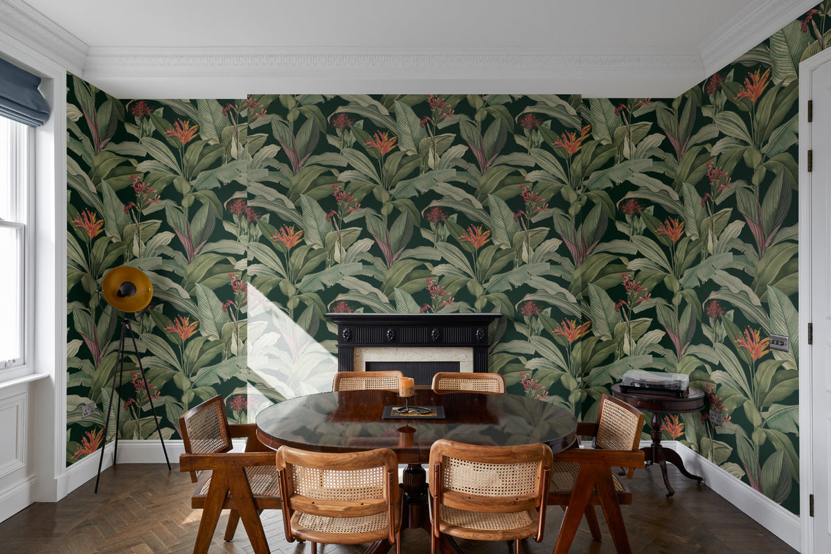 The Heliconia Hall wallpaper in deep jungle green behind a dining table