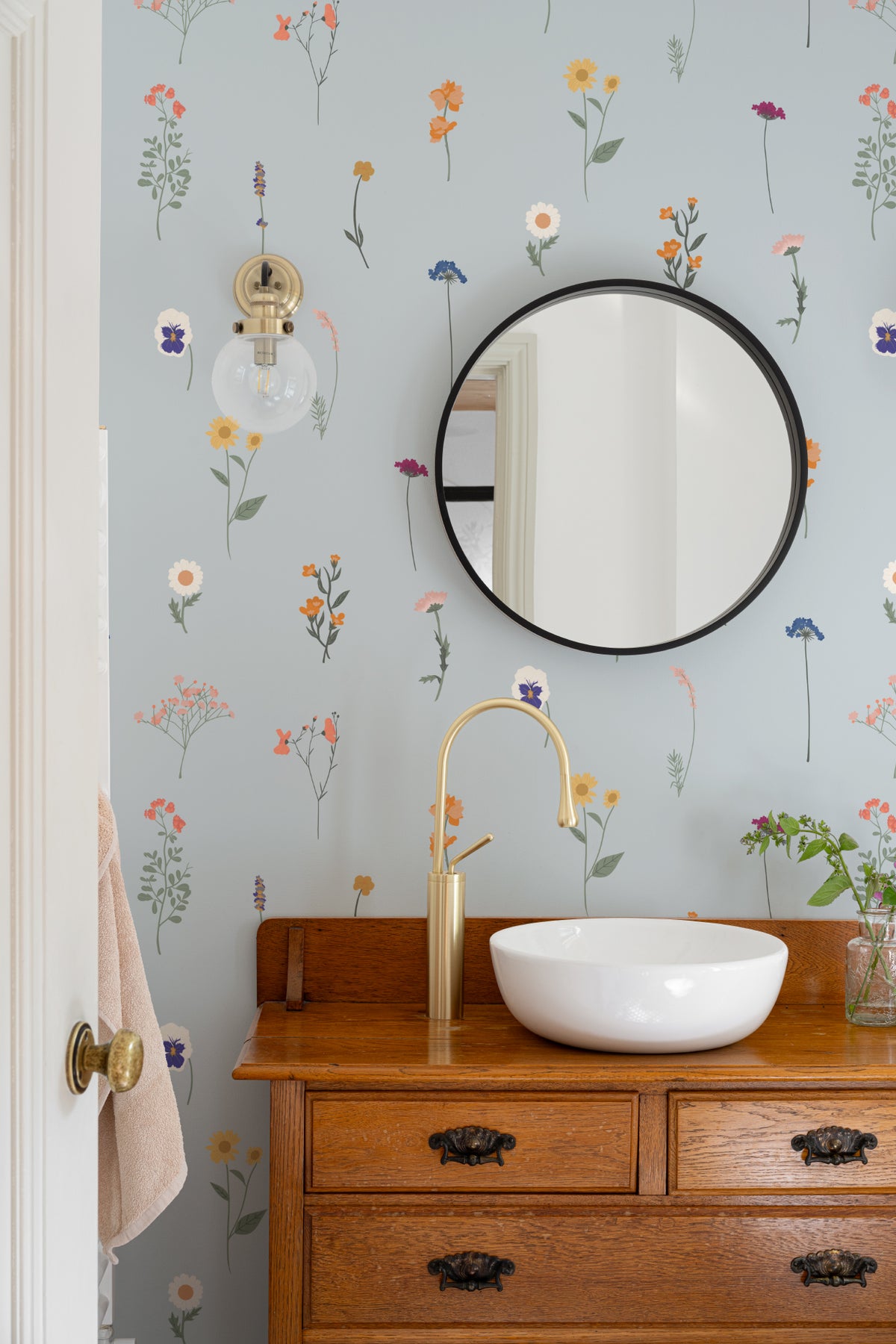 The Herbarium Press wallpaper in mist blue in a styled room setting