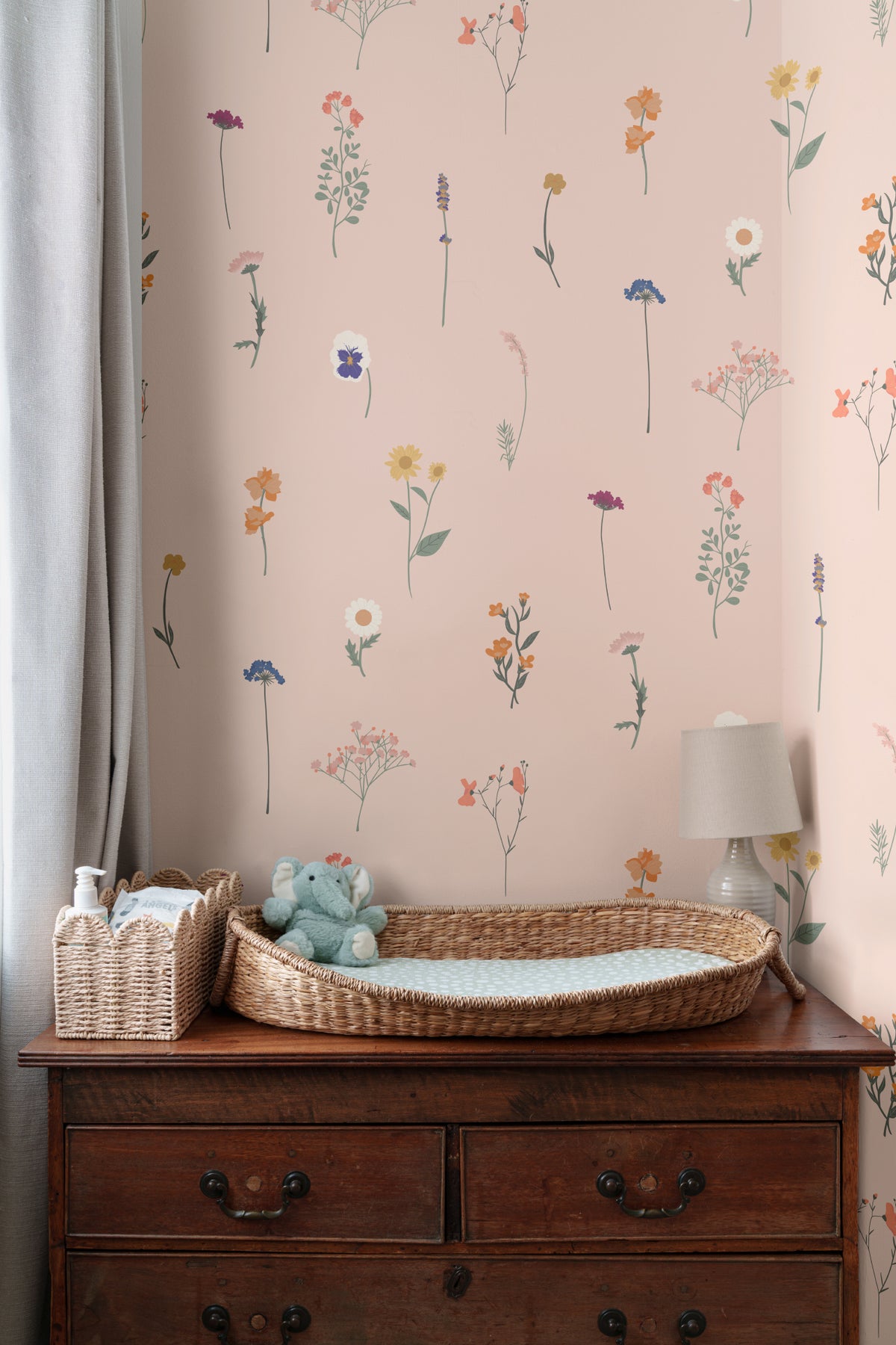 The Herbarium Press wallpaper in soft blush behind a styled console
