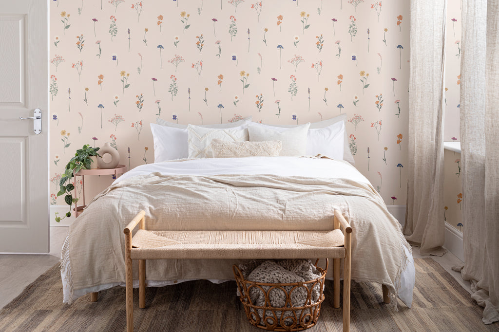 The Herbarium Press wallpaper in soft blush in a calm bedroom setting