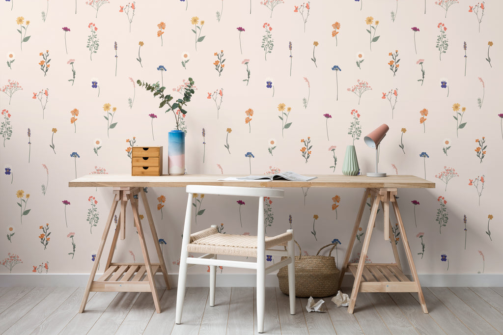 The Herbarium Press wallpaper in soft blush behind a desk in a home office