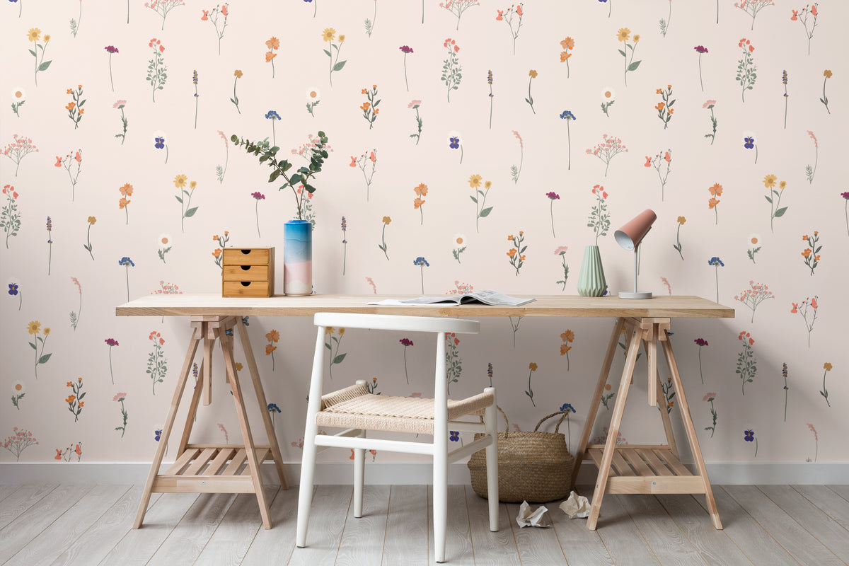 The Herbarium Press wallpaper in soft blush behind a desk in a home office