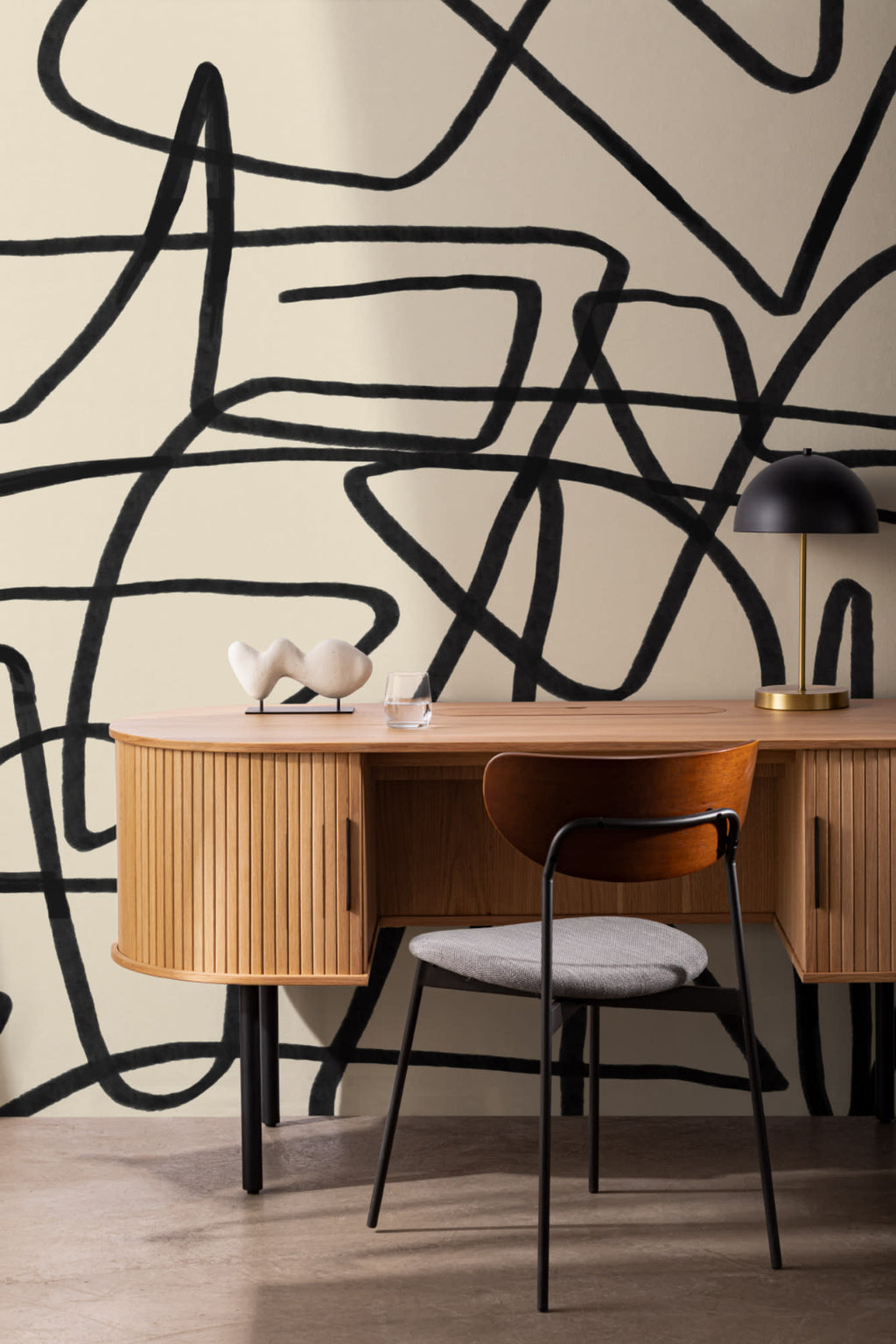 The Ink Gesture mural in black and parchment behind a desk in a home office