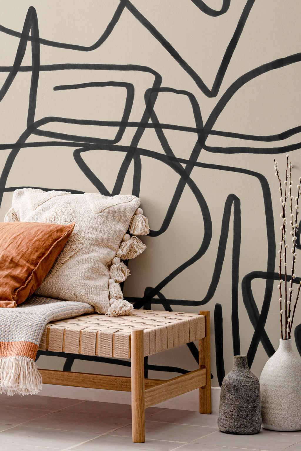 The Ink Gesture mural in black and parchment behind seating in a living room