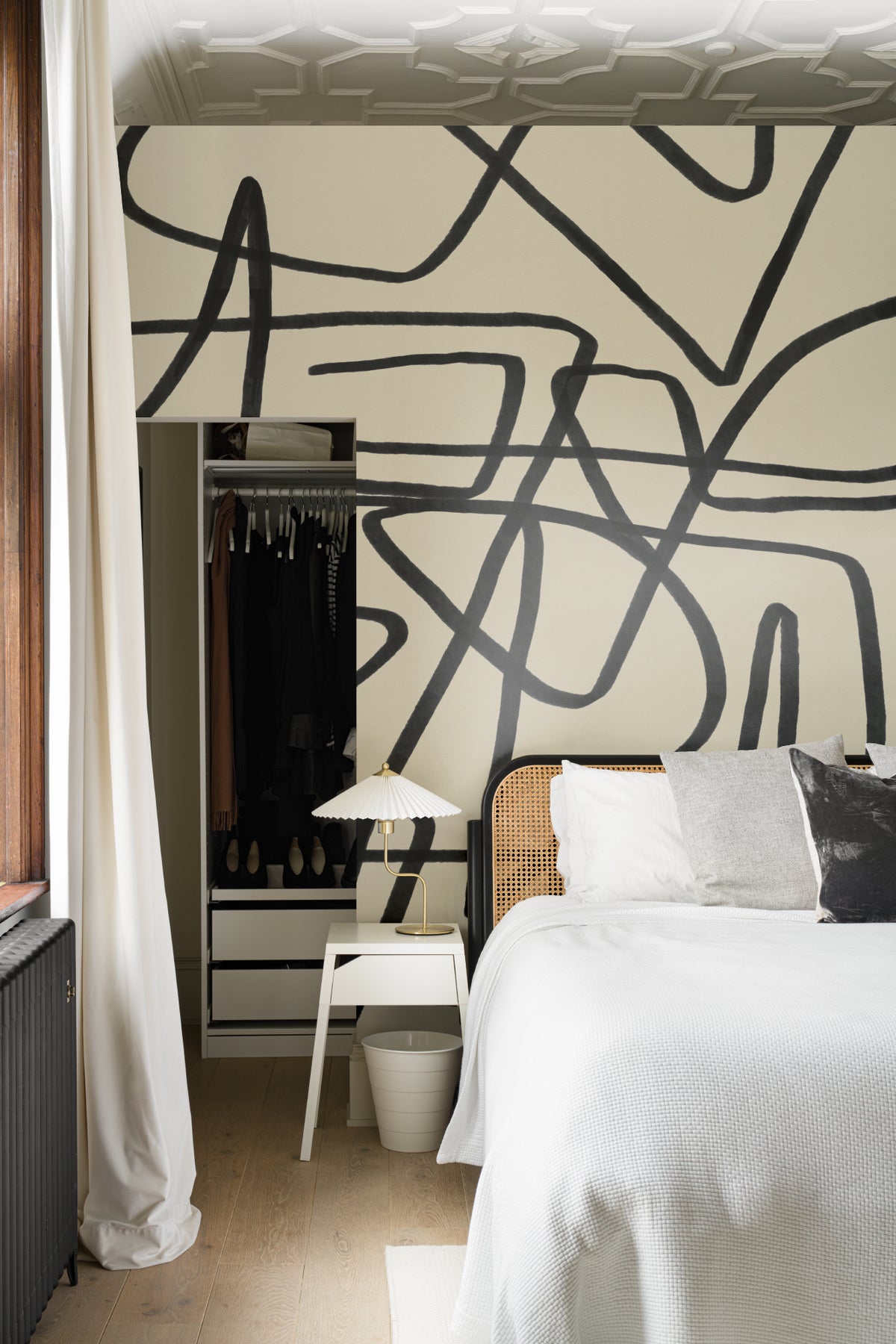 The Ink Gesture mural in black and parchment behind the bed in a bedroom