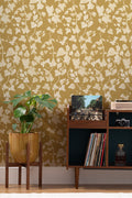 The Ivy Rectory wallpaper in mustard gold behind a styled console