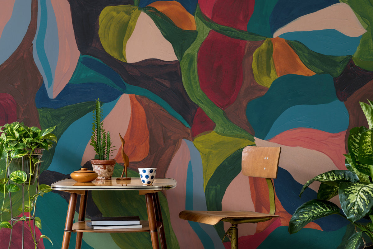 The Jewel Foliage mural in teal and coral behind a desk in a home office
