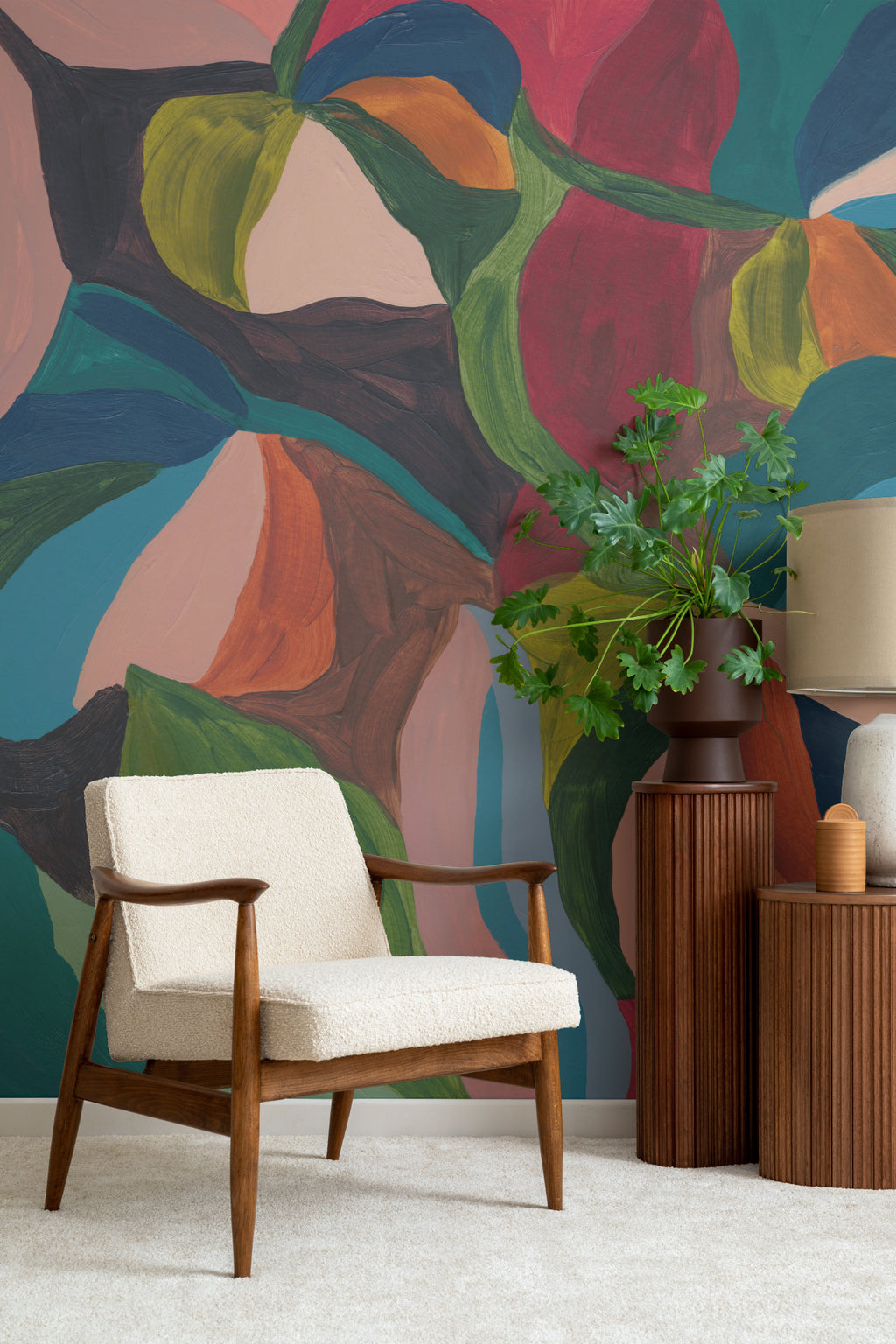 The Jewel Foliage mural in teal and coral in a living room