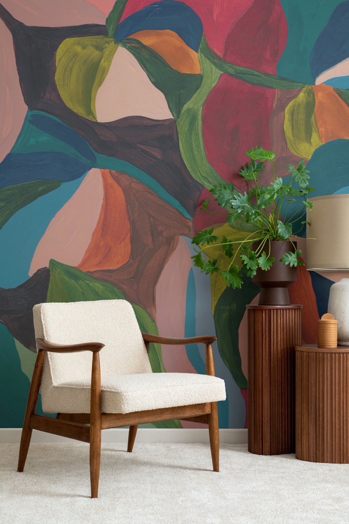The Jewel Foliage mural in teal and coral in a living room