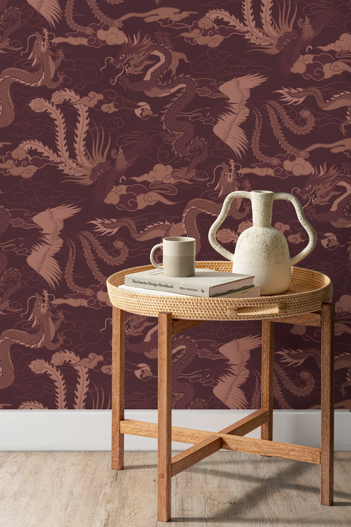 The Lacquer Palace wallpaper in oxblood and rose behind a styled console