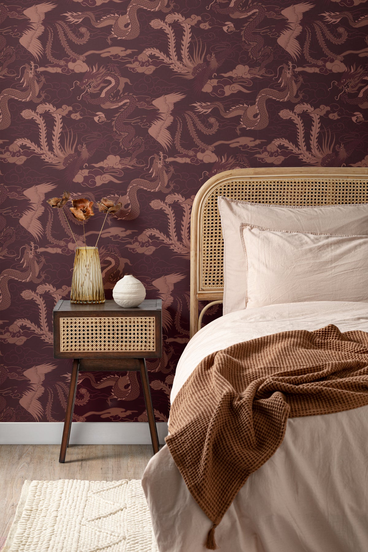 The Lacquer Palace wallpaper in oxblood and rose behind the bed in a bedroom