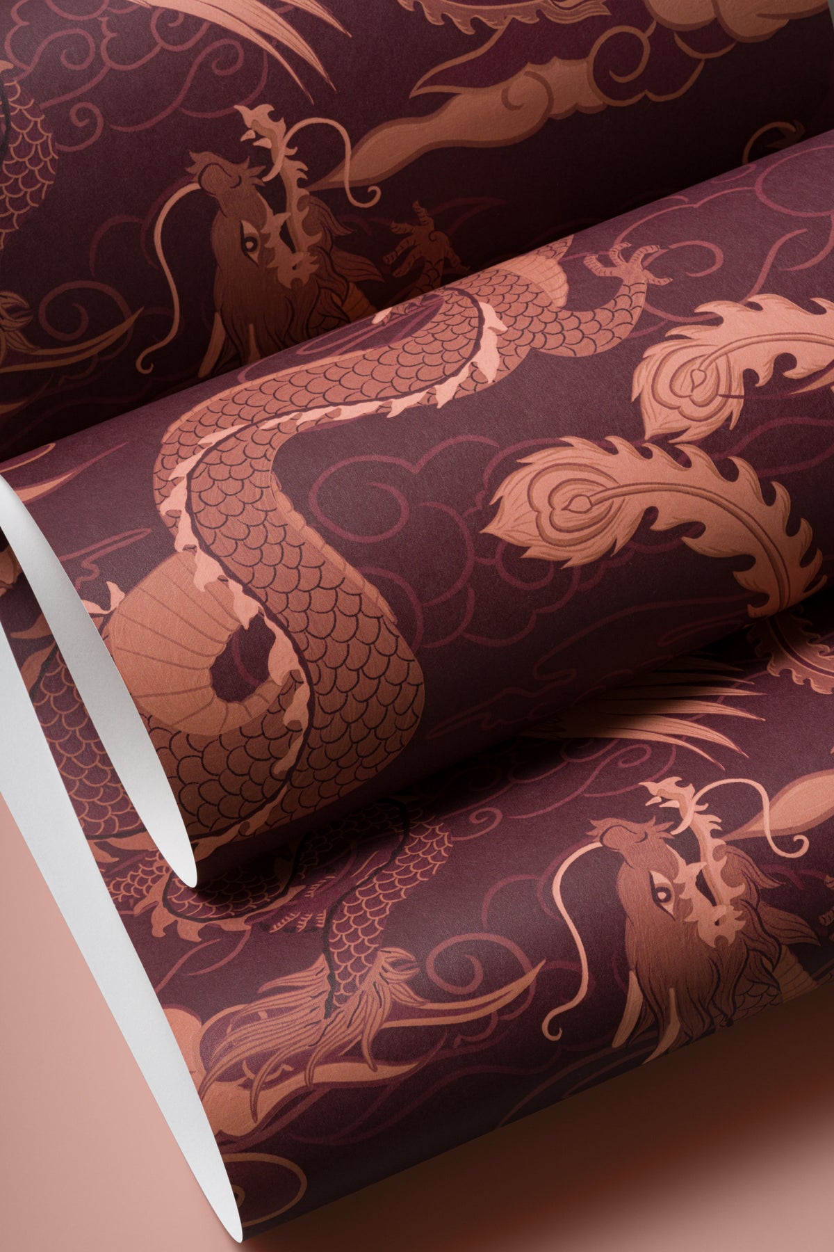 Angled detail of The Lacquer Palace wallpaper in oxblood and rose
