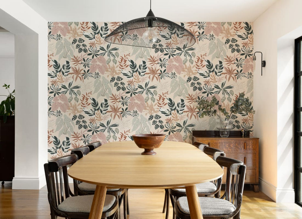 The Leafy Solarium wallpaper in warm sand and pine behind a dining table