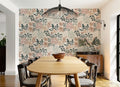 The Leafy Solarium wallpaper in warm sand and pine behind a dining table