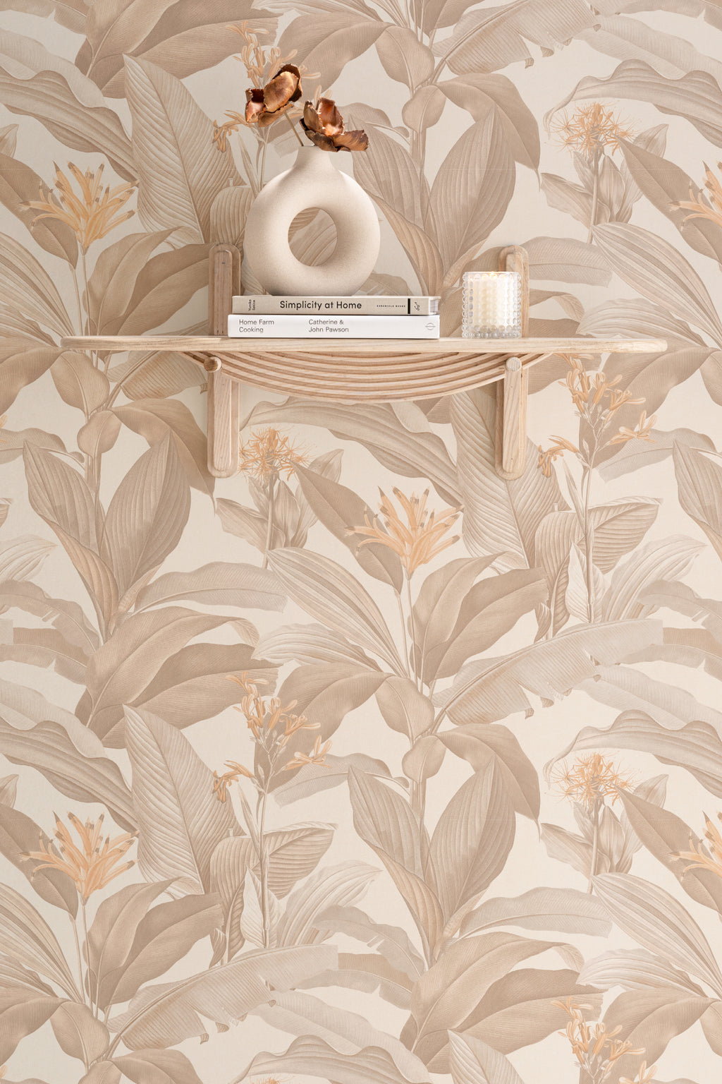The Leafy Veranda wallpaper in sand and toffee as a backdrop to styled furniture