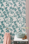 The Leopard Lounge wallpaper in teal behind a styled console
