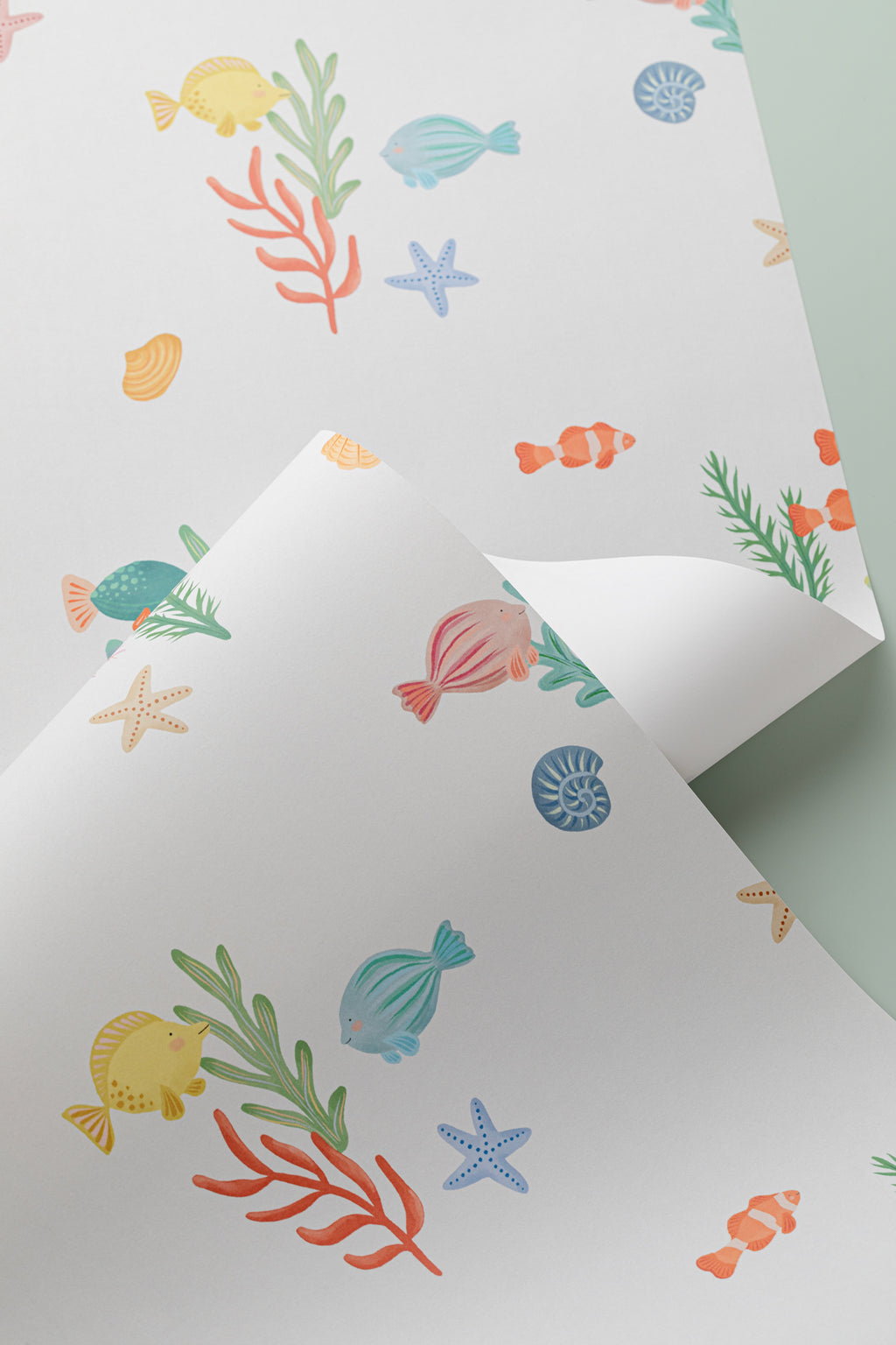 Angled detail of The Little Rockpool wallpaper in coral and seafoam