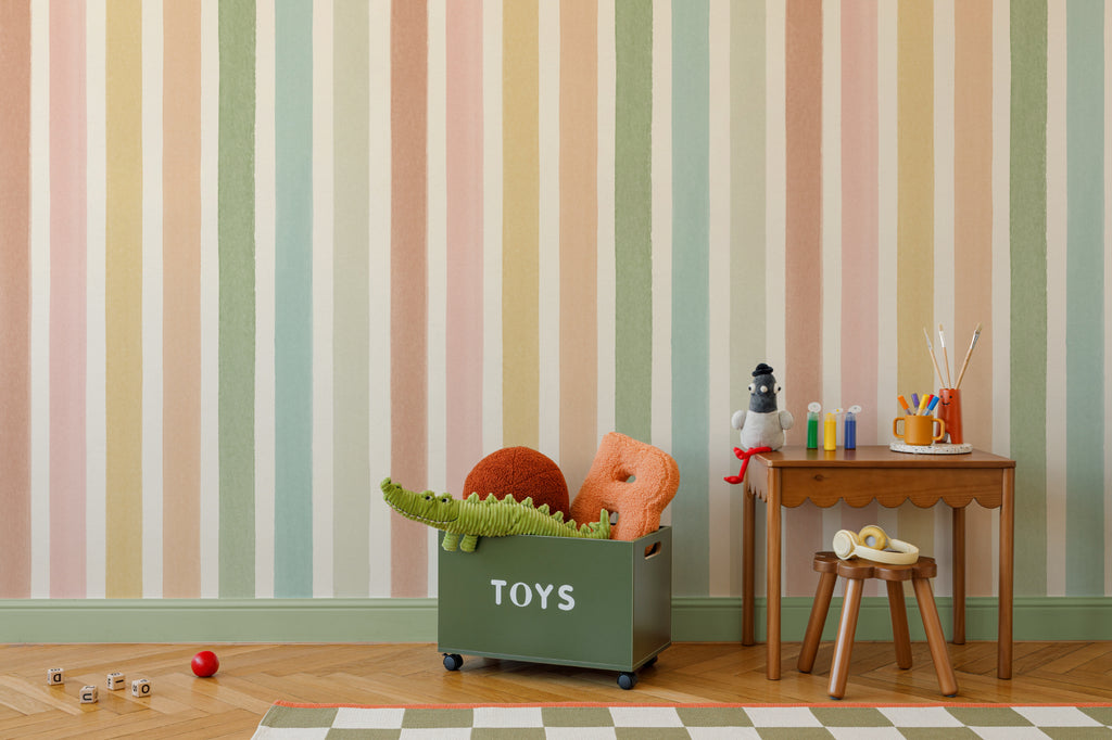 The Macaron Stripe mural in peach and mint on a nursery wall