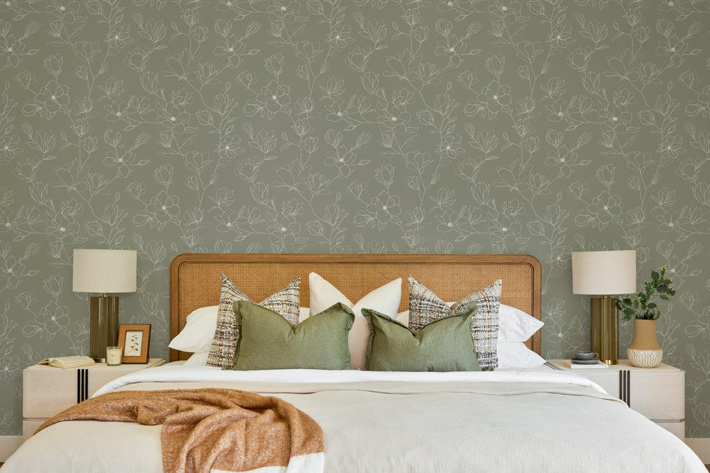 The Magnolia Sketchbook wallpaper in olive sage behind the bed in a bedroom