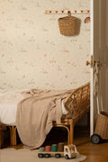 The Mallard Meadow wallpaper in buttermilk and beige behind the bed in a bedroom